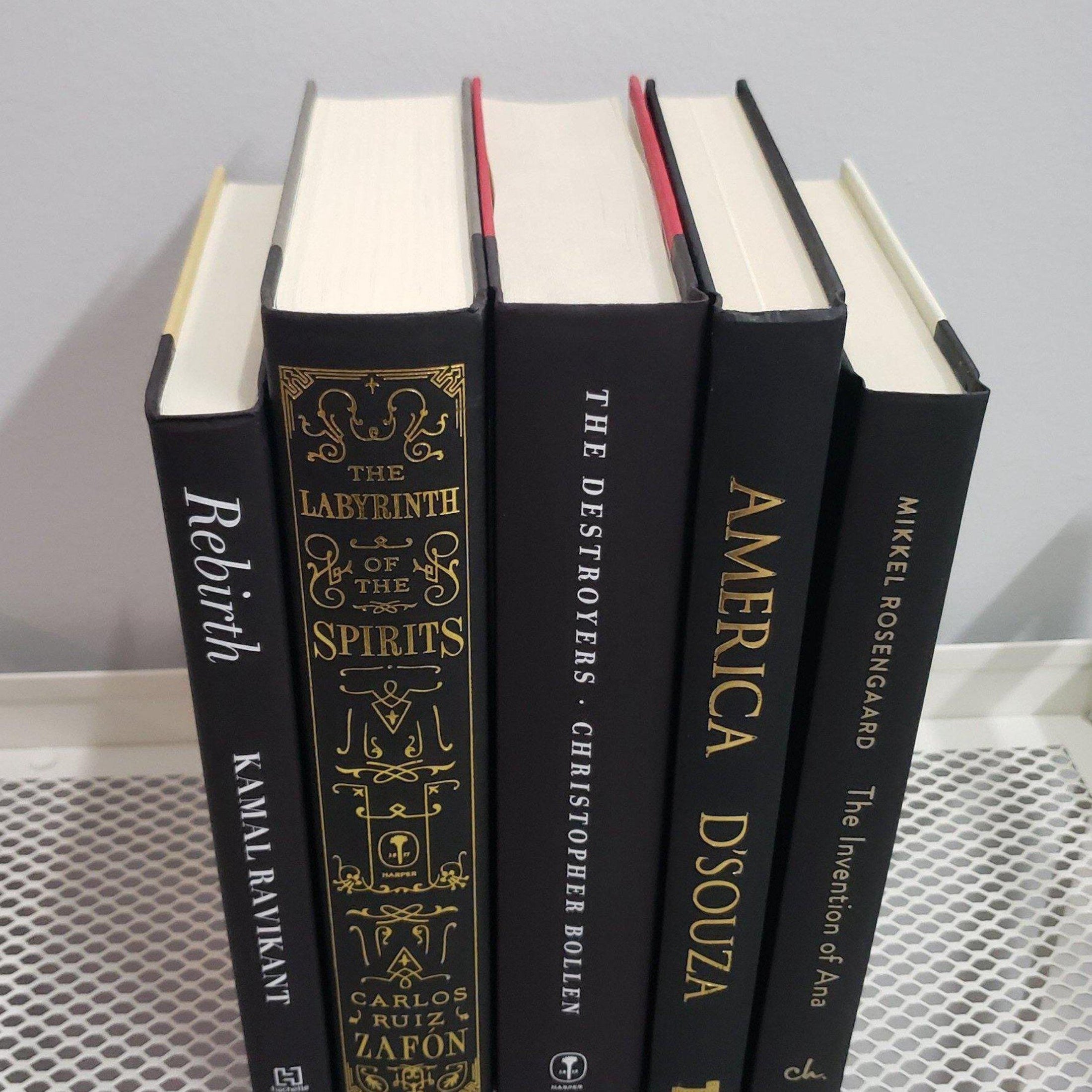 Stack of Black Books Gold & White Accent. Real hardcover books staged and used for decorating.