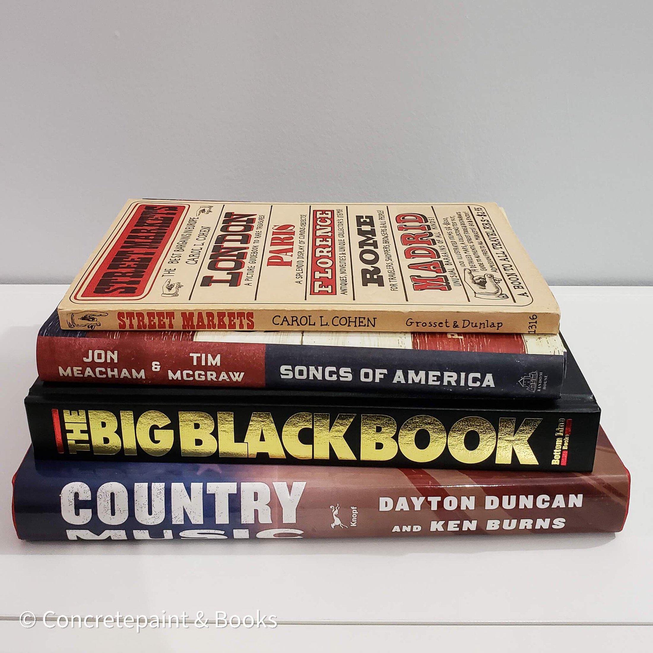 Stack of real books staged for display. Large and small books used for decorating. Country music books.