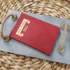 Concrete Tray with jute twine handles and red leather antique book on top. Decorative book and tray are staged for home decorating.  