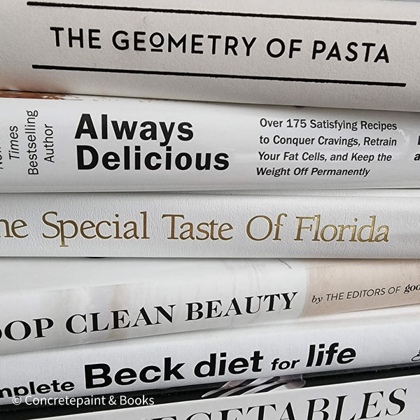 Stack of white decorative cookbooks for display. 