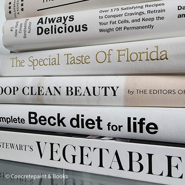 Stack of all white decorative cookbooks for display. 