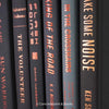 Set of real books on display. Black and gray books for men's home decor 