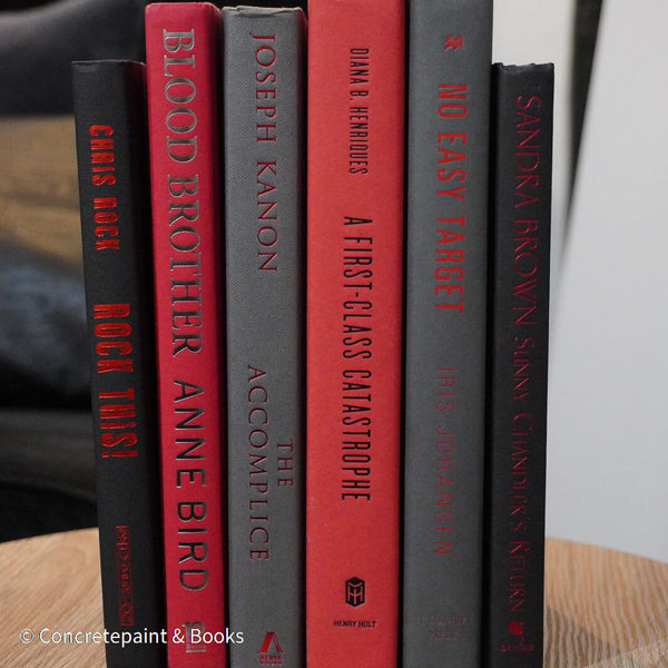 Black, gray, and red books for display. 