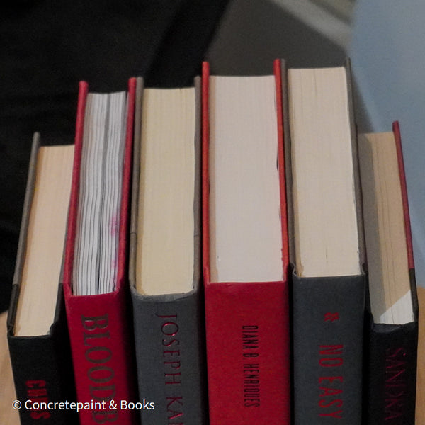 Black, gray, and red books for display. 