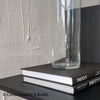 Set of real books  and glass vase staged for display.
