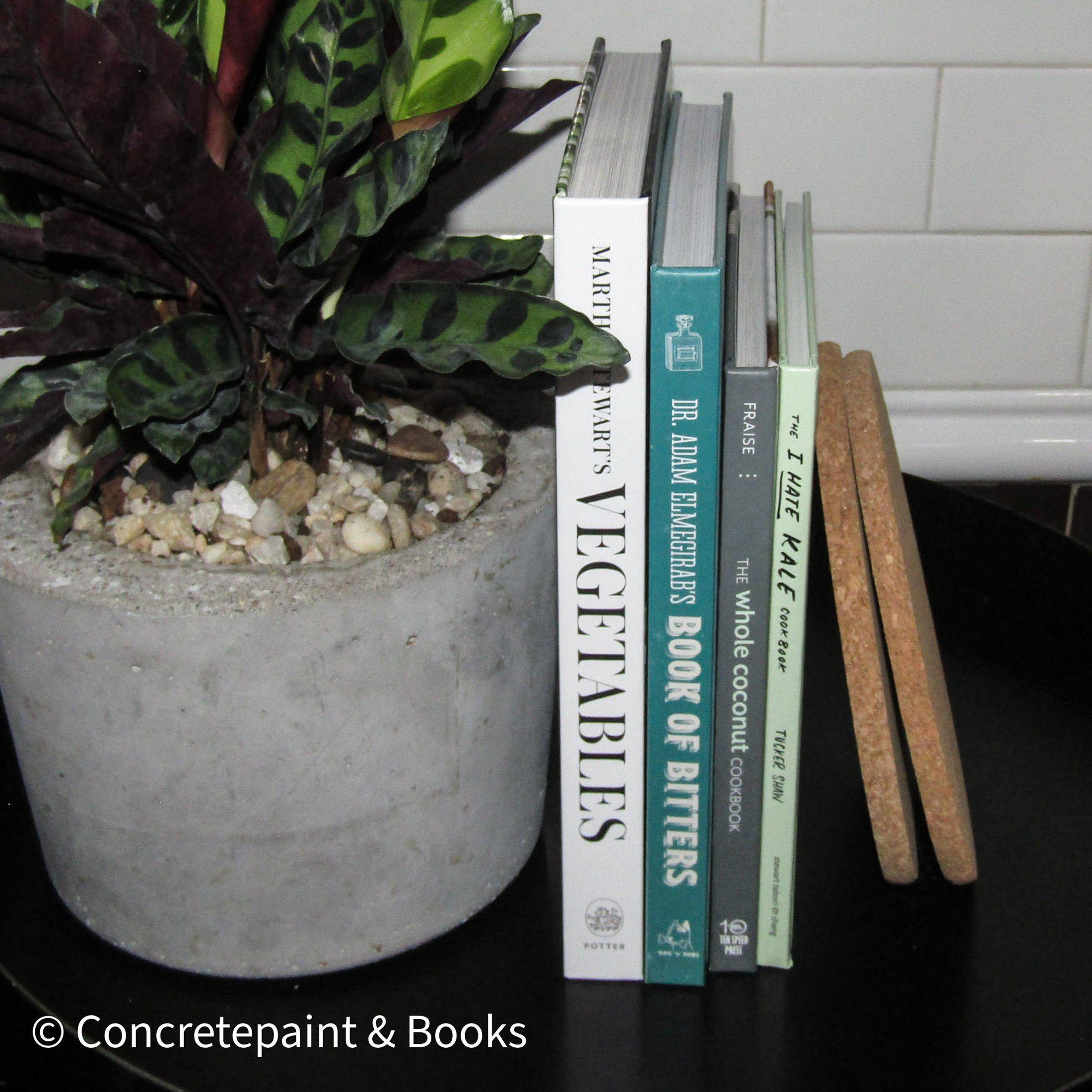 staged kitchen decor with hardcover cookbooks and cork trivets from ikea