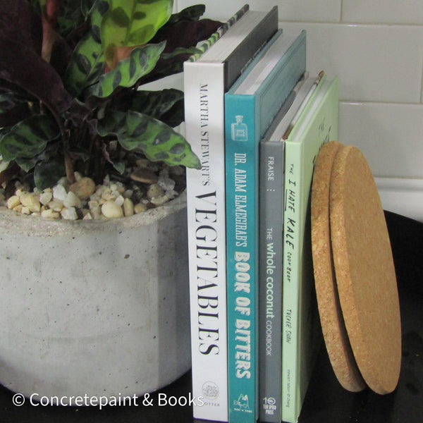staged kitchen decor with hardcover cookbooks and cork trivets from ikea