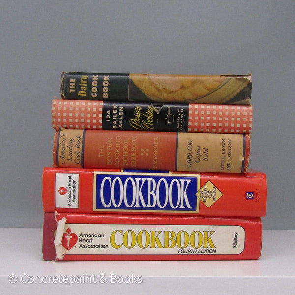 Set of vintage cookbooks with dustcovers in red white and brown.