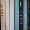 Navy, neutral, and green books on display. Real hardcover books for decorating shelves.