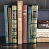 Brown and green hardcover book display for home decor. Nature tone books used for mens home decoration. 