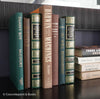Brown and green hardcover book display for home decor. Nature tone books used for mens home decoration. 
