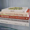 Stack of neutral decorative cookbooks for display. 