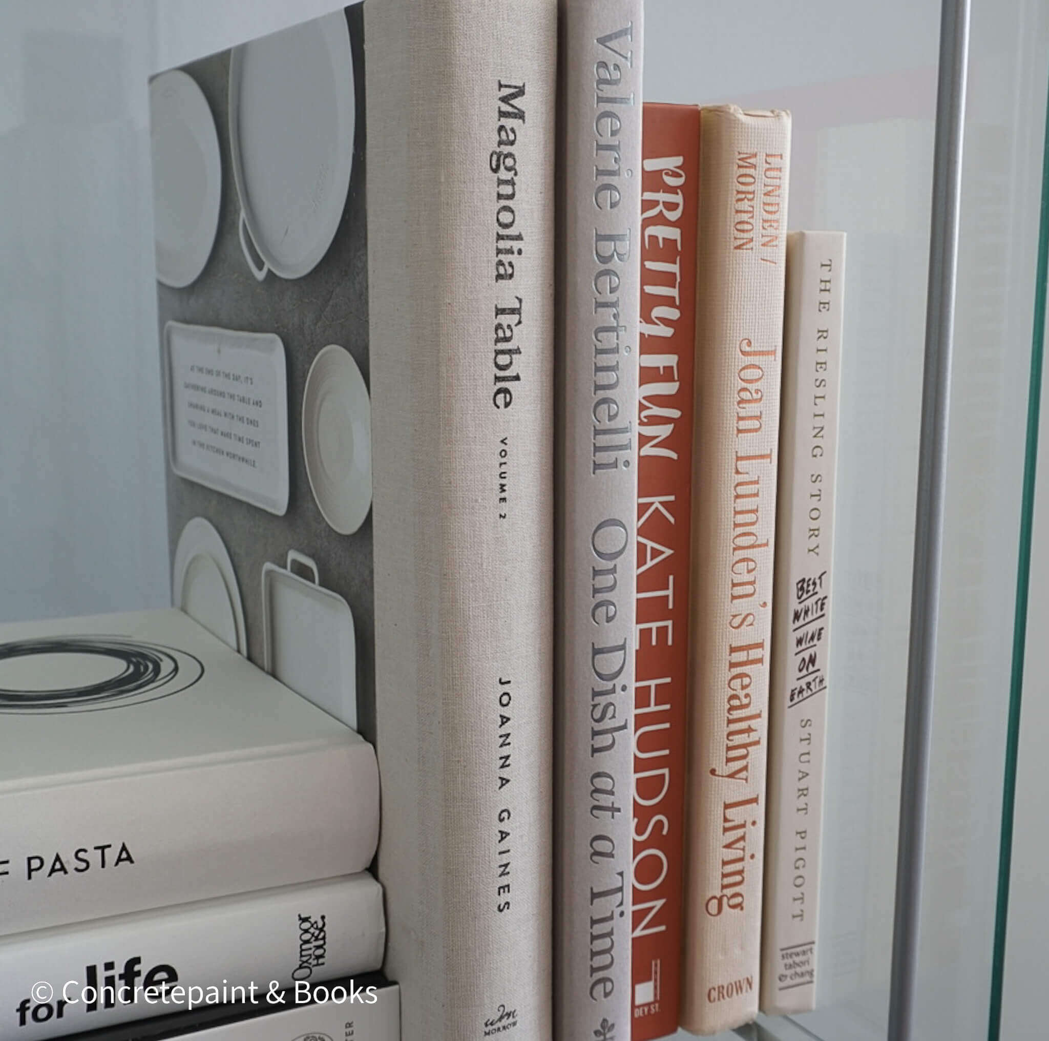 Stack of neutral decorative cookbooks for display. 