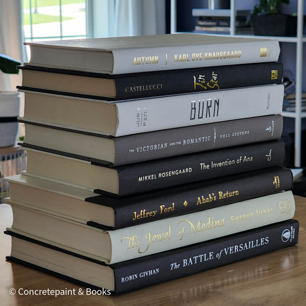 Neutral, black and gray books on display. Real hardcover books for decorating shelves.