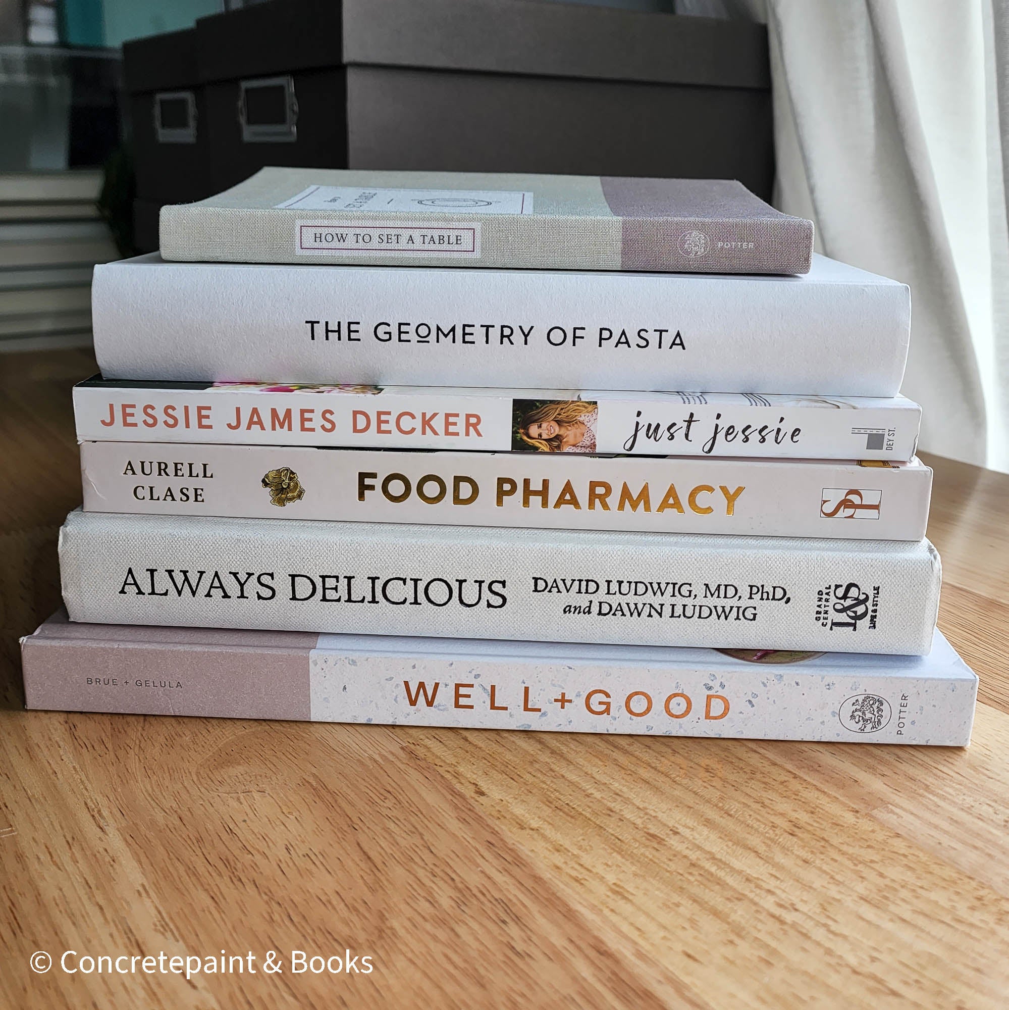 stack of cookbooks for decorating kitchen. White and blush kitchen decor. 