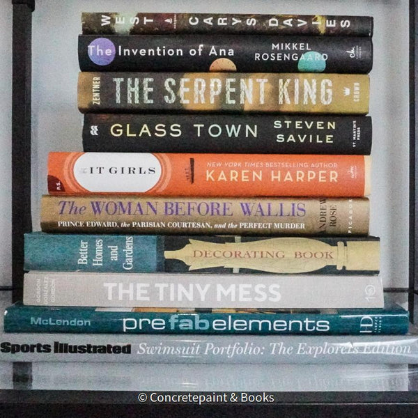 Large stack of hardcover books for reading, entertainment, and staging used for decorating display. Teal, neutral, black , and mint green décor. 