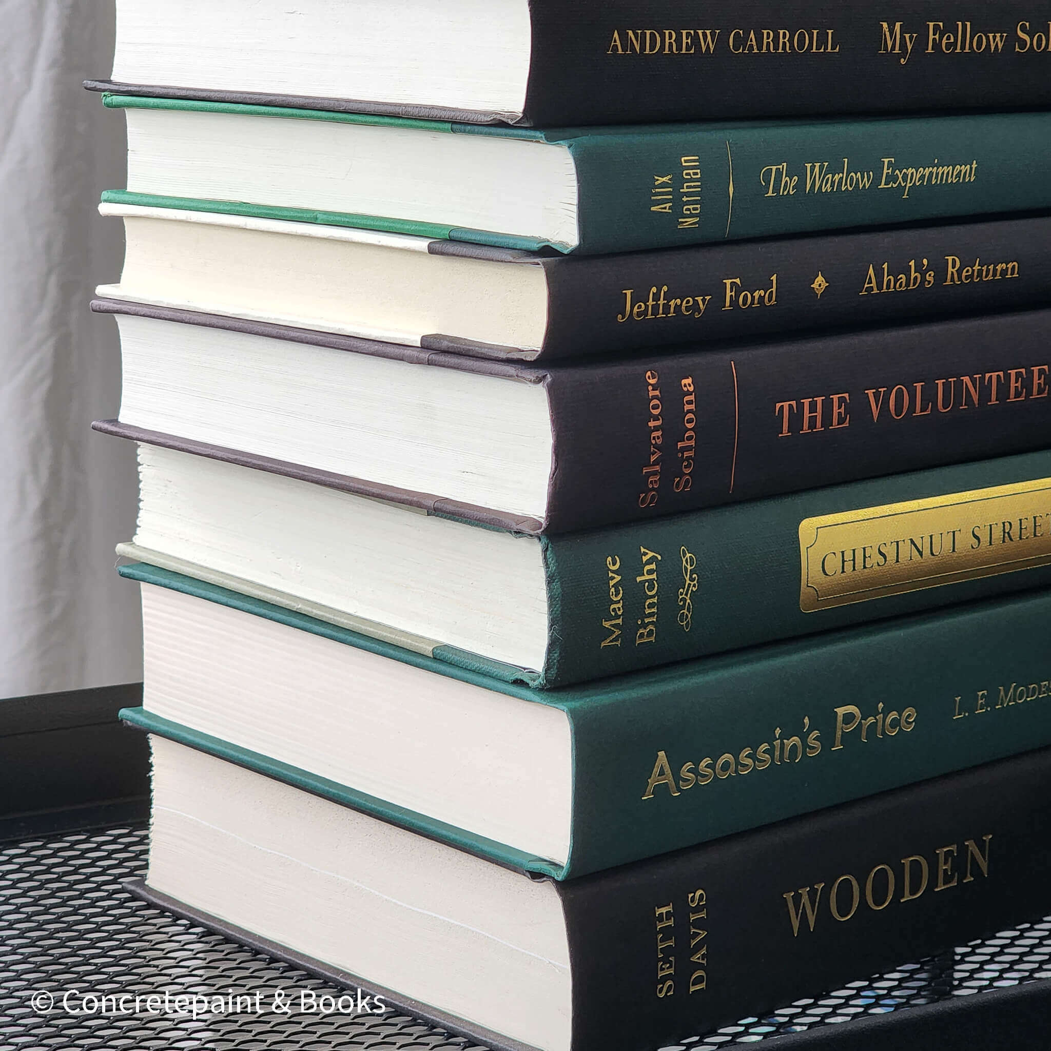 Set of green and black hardcover books used for decorating. Book desplay used for men's shelf decor.