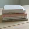 Stack of hardcover books used to decorate. Blush and neutral display books.