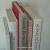 Stack of hardcover books used to decorate. Blush and neutral display books.