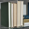Olive green and neutral books used as shelf decor. Set of books for reading and decorating.