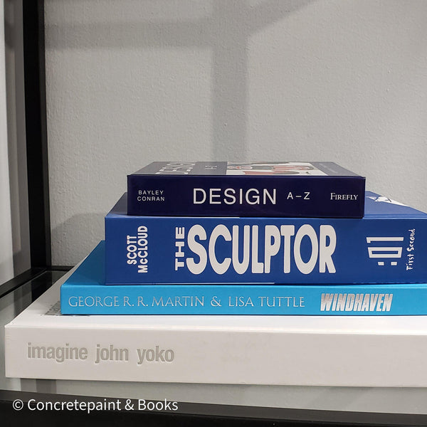 Stack of white and blue hardcover coffee table books. 