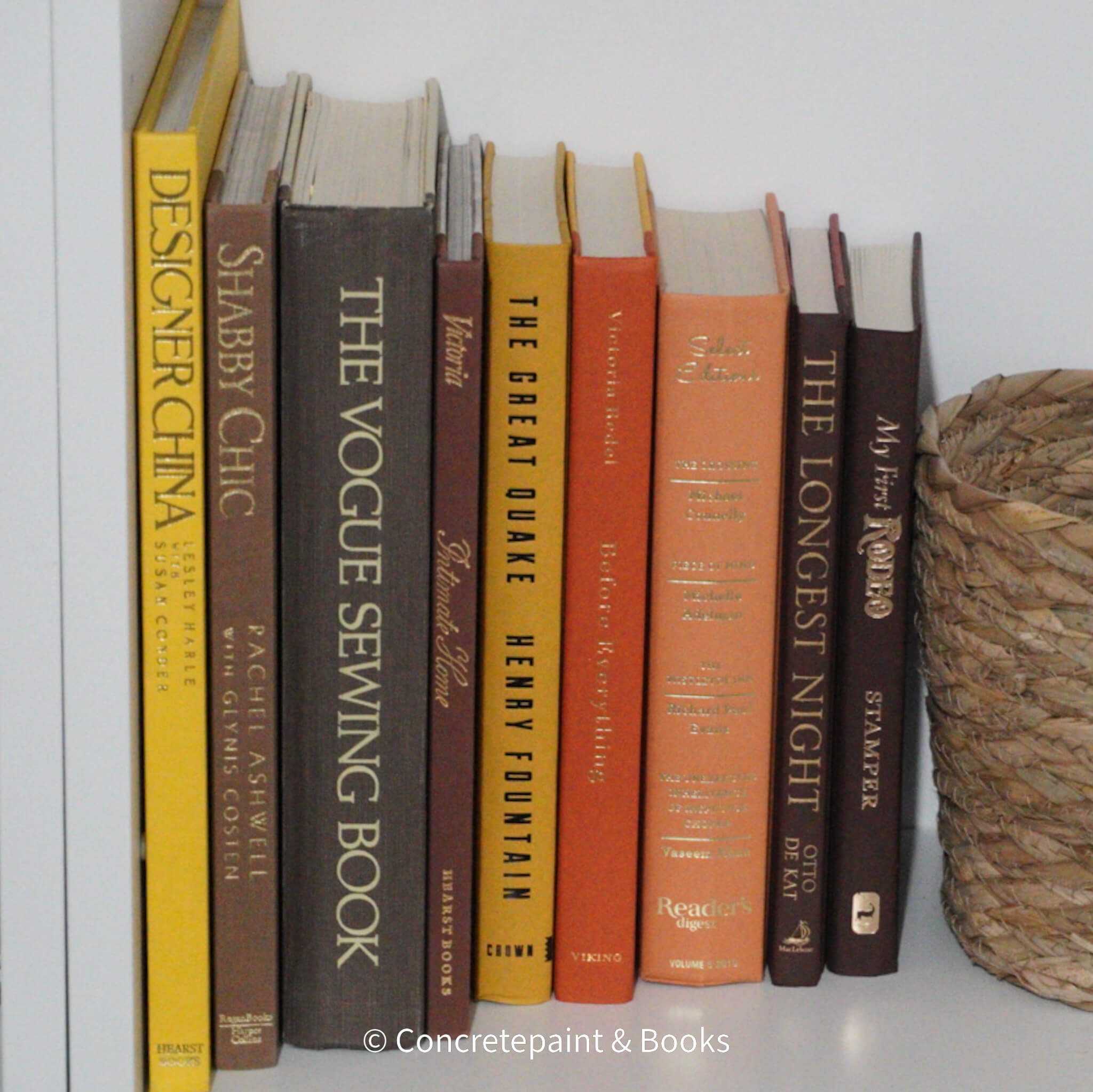 Set of decorative large books for display. Brown, yellow, and orange vintage books on bookshelf. 