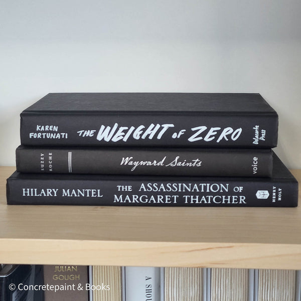 Set of black books with white font for home display and decoration.
